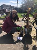 Maia planting her Gardening Club seeds